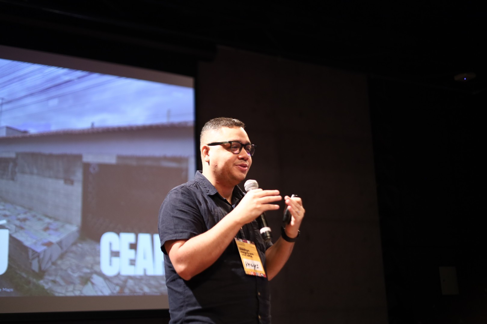 Stylized blue duotone portrait of a person facing the camera with arms crossed